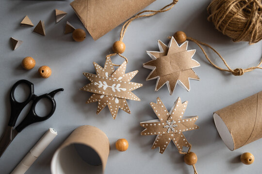 DIY gift handmade Christmas tree decorations: toy snowflakes made from toilet paper rolls. paper craft for kids. create art for children.