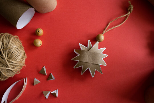 DIY gift handmade Christmas tree decorations: toy snowflakes made from toilet paper rolls. paper craft for kids. create art for children.