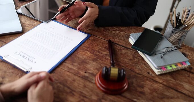 Legal professional consulting client in a modern office, offering expert advice and legal services, discussing important documents while providing professional support and justice