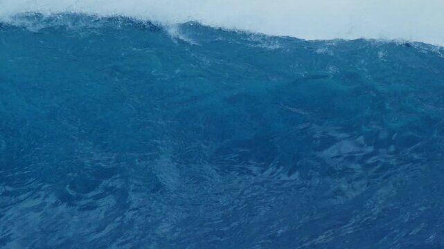 Ocean wave rolls and breaks in the Maldives