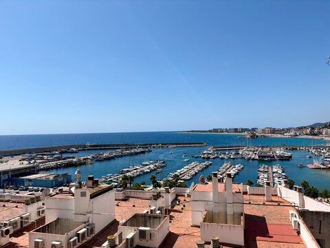 High angle panoramic view of a coastal marina with boats and yachts yacht club blue sea clear sky
