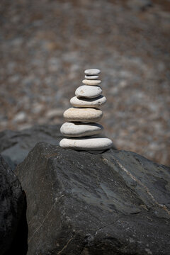Longues-sur-Mer, France - 08 10 2026: Detail of a cairn in the pebble beach in sunny sky