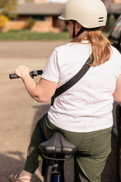 Over the shoulder view of a woman on an e bike
