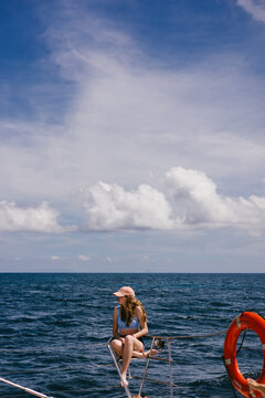Young woman enjoys a boat ride on the open ocean