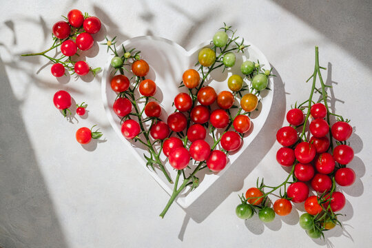 Cherry tomatoes on the vine in a heart shaped bowl