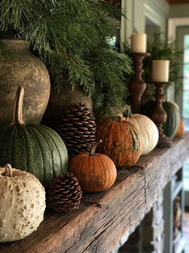 Fall decor pumpkin pinecone rustic wood candle greenery holiday still life seasonal cozy autumn fall decor with pumpkin pinecone and greenery rustic wood mantel next to candle creating warm