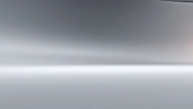Abstract background with smooth silver metallic texture and soft lighting gradients.