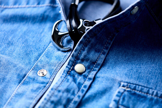 Close up of blue denim shirt with buttons. Soft focus.