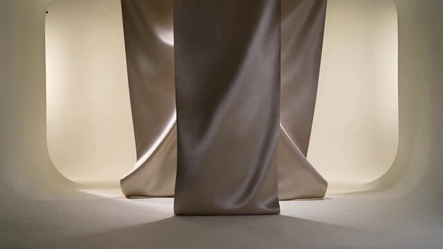 Fan-starting center satin panel rippling, side panels sliding on studio floor, forming even spacing