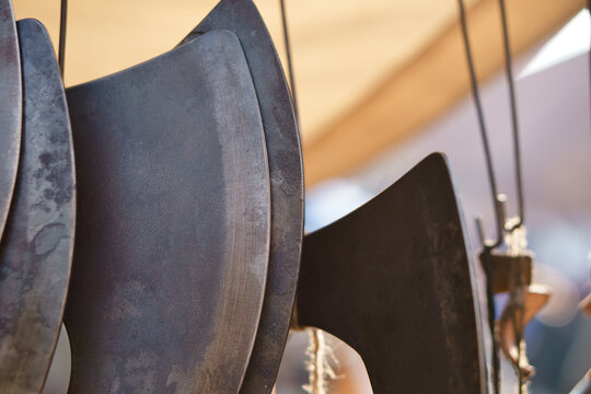 Forged Axe Blades Suspended on Display at a Market.