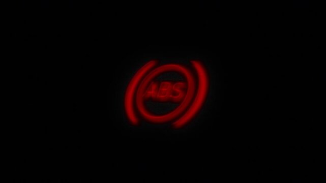 Glowing crimson antilock braking system indicator pulses in darkness malfunction warning. car repair, dashboard alerts, mechanic training, road safety, hydraulic faults, tire grip, accident prevention