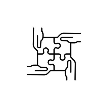 Four hands holding puzzle pieces together as a symbol of teamwork and unity with teamwork