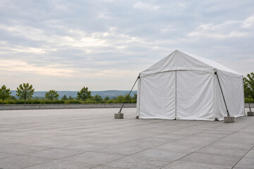 Closed White Response Tent in an Empty Courtyard © ornando