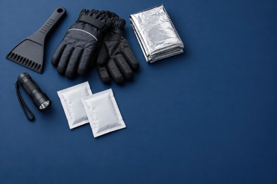 Compact winter car emergency accessories on navy background