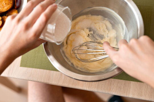 Pouring floor into boil, mixing dough for homemade bakery, authentic lifestyle home cooking process, soft selective focus