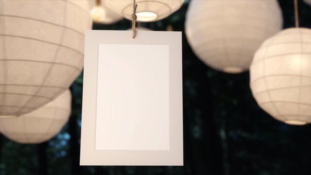 Blank hanging sign mockup surrounded by paper lanterns at night.