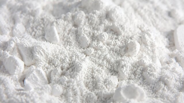 White chalk powder texture closeup. Crushed mineral dust and cosmetic flour surface. Macro background of magnesium carbonate particles