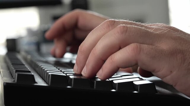 Detailed close-up of fingers pressing keys on a computer keyboard during office work, representing digital productivity, writing, programming and online communication.