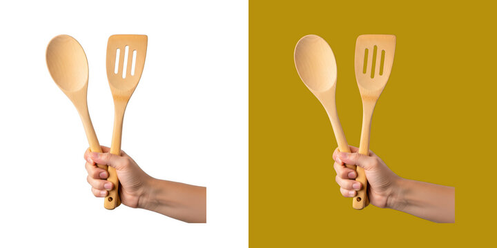 Person hand holding two wooden kitchen utensils for cooking food transparent png