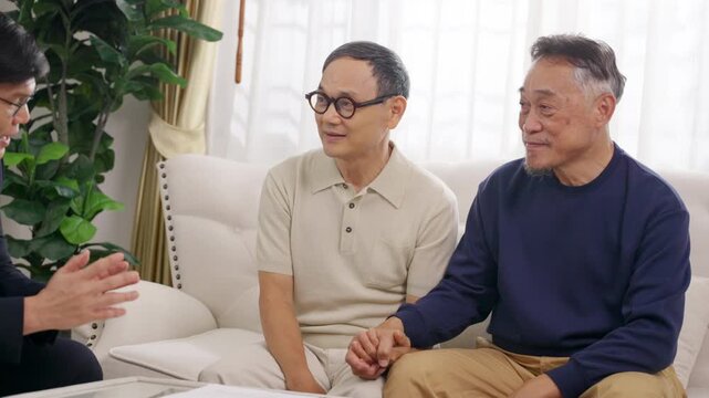 Asian senior gay couple meeting financial advisor or insurance agent at home, discussing retirement plan health insurance, financial security, future protection and sign agreement document together
