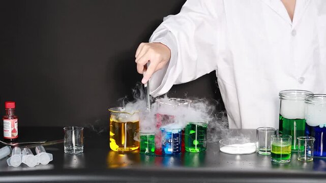 A scientist adds dry ice to colorful liquids in beakers, creating a captivating and dynamic chemical reaction with flowing smoke, showcasing a fascinating educational experiment.