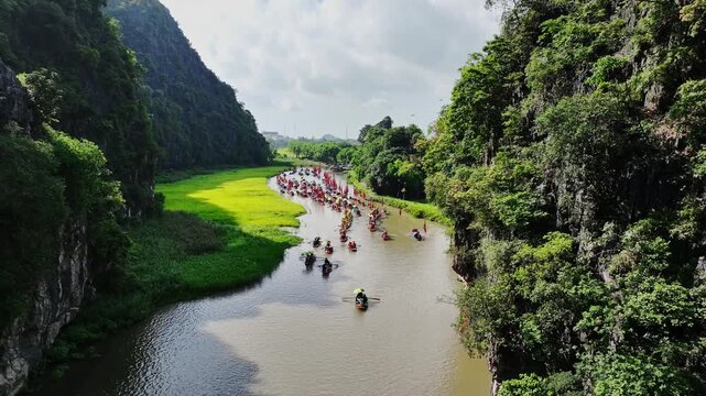Tam Coc festival procession in karst gorge during the Tam Coc festival in Ninh Binh, Vietnam