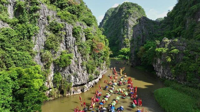 Festival boats entering Tam Coc limestone gorge during the Tam Coc festival in Ninh Binh, Vietnam
