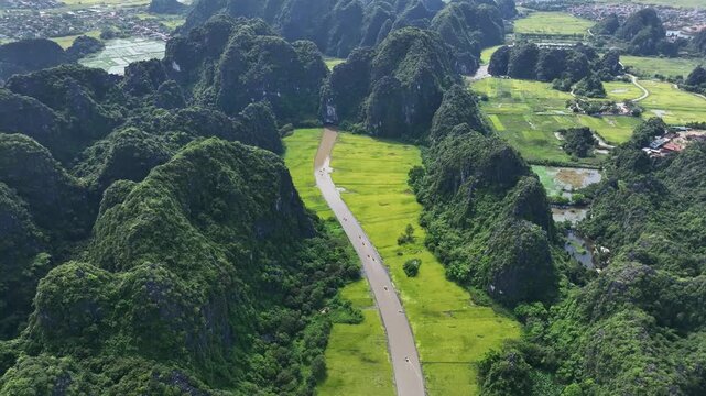 Road winding through Tam Coc limestone valley in Tam Coc, Ninh Binh, Vietnam