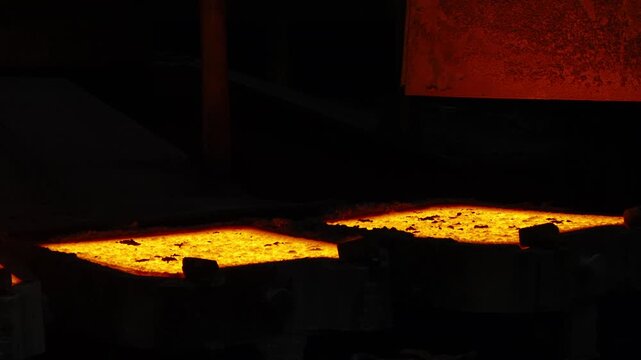Molten Metal Glowing in Casting Molds at Industrial Foundry