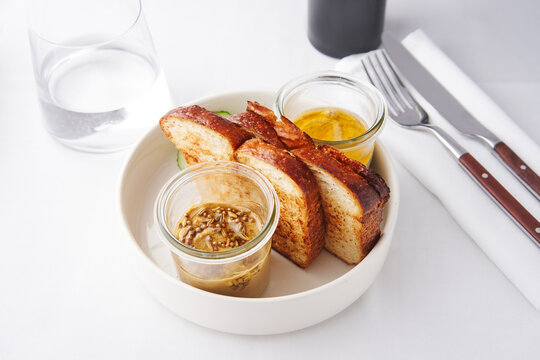 Sourdough bread slices with dips served in jars, restaurant menu, casual dining experience