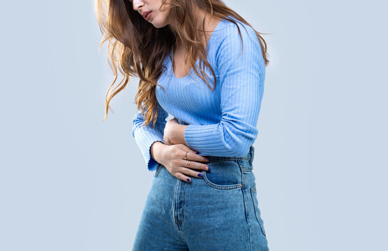 Girl having a stomachache. Woman suffering from abdominal pain. Woman stomach ache. Woman touching his stomach. Stomach pain and others stomach disease concept