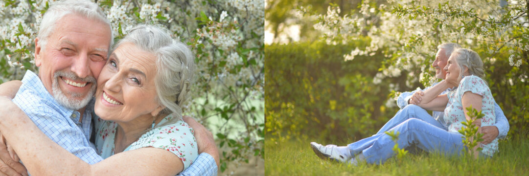 Happy senior couple relaxing in spring garden with blooming flowers