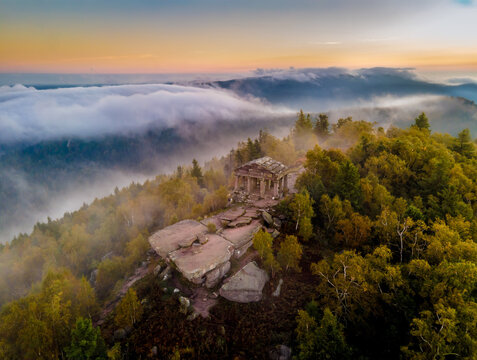 FRANCE. ALSACE. BAS-RHIN 67 GRANDFONTAINE. AT THE SUMMIT OF DONON, THE TEMPLE STANDS OUT IN THE AUTUMN MIST, OFFERING A MYSTICAL SILHOUETTE IN THE HEART OF THE VOSGES MOUNTAINS.