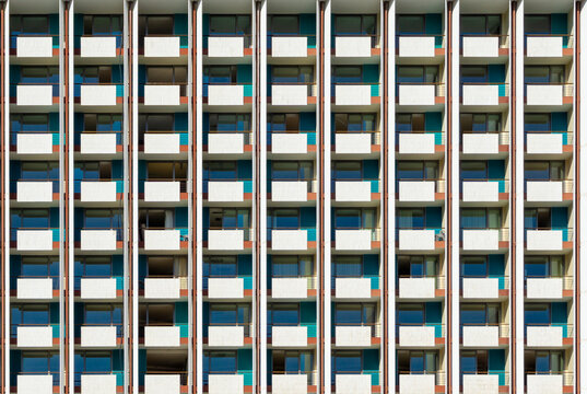Athens hotel building facade featuring a striking pattern of repeating balconies and windows, creating a modern architectural backdrop with a strong sense of rhythm and design
