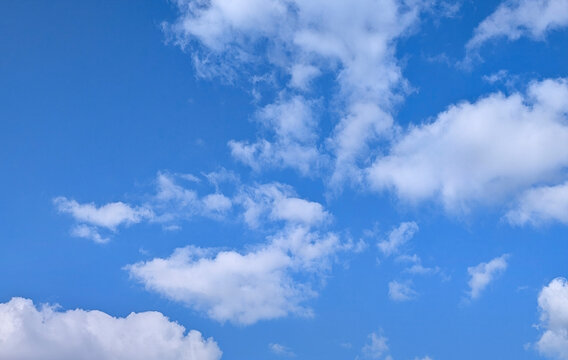 Bright blue sky with fluffy clouds during the day in an open area