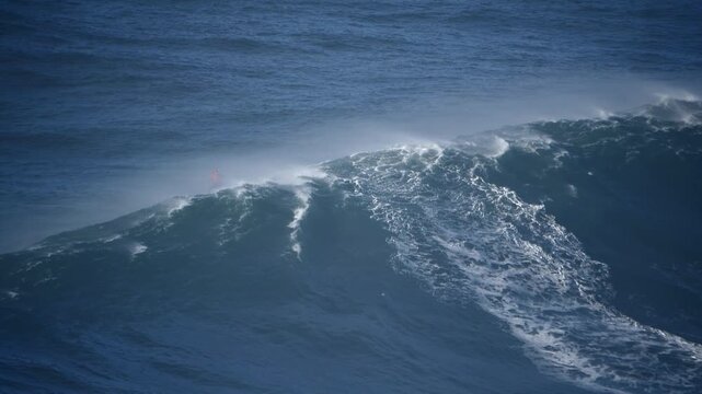 Jetski passing through a giant wave