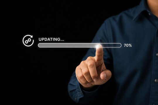 Man pointing at a glowing digital progress bar showing updating status against black background