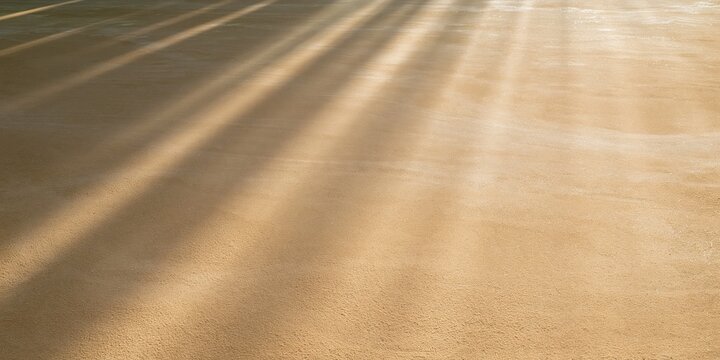 Smooth clay surface in a threshing yard with warm raking light beams, creating an earthy background with copy space for autumn design