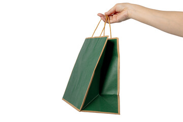 Obraz premium Green paper bag, shopping bag and hand on transparent background.