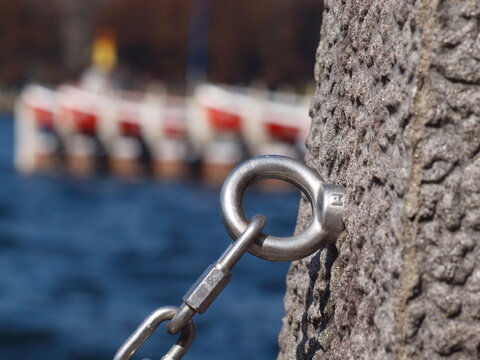 Metal Chain Attached to an Eye Bolt in a Stone Post