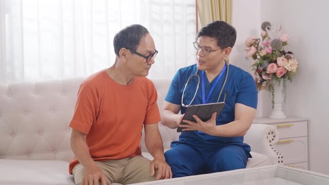 Doctor examine and advice medical treatment plan on digital tablet to senior man patient. Nurse or caregiver take care elderly people at nursing home. Medical healthcare wellness assistant services.
