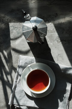 Coffee pot and a cup served on linen tablecloth