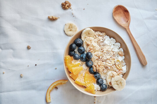 Healthy breakfast with oatmeal cereal, banana, blueberry, orange