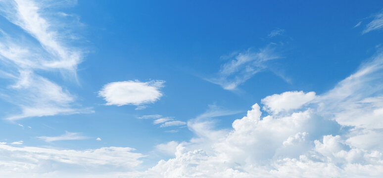 Clear blue sky with wispy white clouds