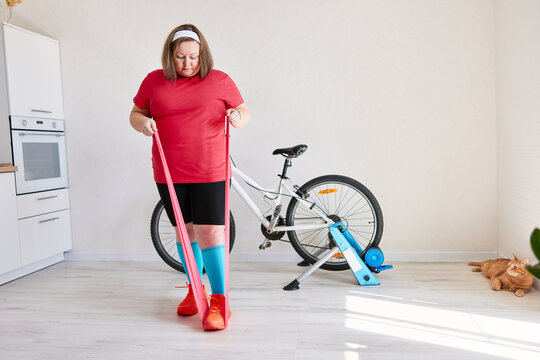 Woman exercising with resistance band at home training