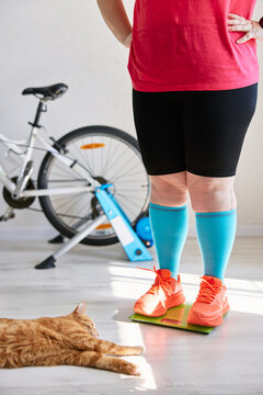 Person checking weight on scale before home training