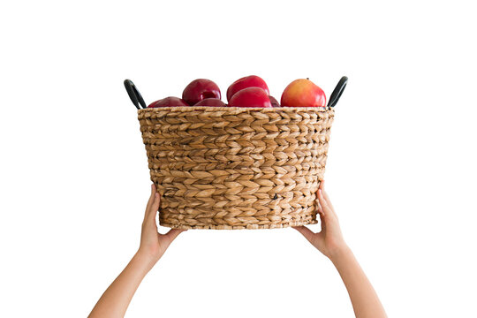 Red apples in a rustic woven basket held by hands, isolated on a transparent background, fresh organic fruit, healthy food, natural produce, harvest, nutrition, grocery, healthy lifestyle