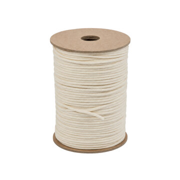 Large spool of natural beige cotton cord, neatly wound on a cardboard reel, isolated on a clean white background