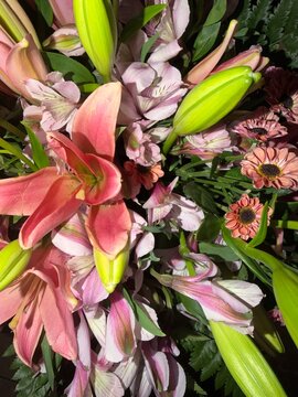 Vibrant bouquet featuring a beautiful arrangement of pink lilies, alstroemeria, and delicate smaller flowers, showcasing nature's elegance and floral design
