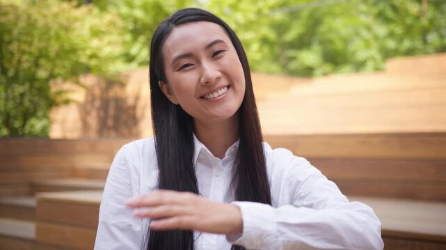 Happy friendly Asian Korean businesswoman showing come here welcome gesture Japanese business woman inviting waving hand looking at camera smiling Chinese female girl smile welcoming join job in city